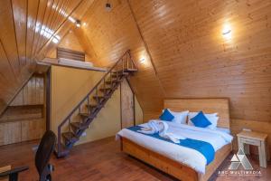 a bedroom with a bed in a wooden house at CASA Resort and Restaurant in Rāmnagar