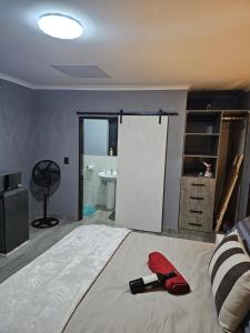 a bedroom with a bed with a bottle of wine on it at Lanico in Witbank