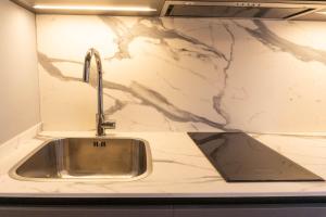 a kitchen sink with a faucet on a counter at Loureira in Pincelo +19 photos