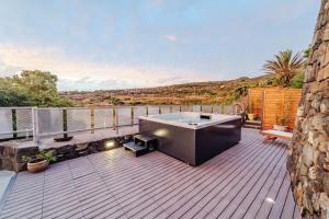 a hot tub on the deck of a house at Alba Chiara & Mila - Sea View, Terrace and Jacuzzi in Tracino +39 photos