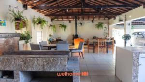 a restaurant with a table and chairs and a dining room at Sitio em Sarapui com piscina e lareira in Sarapuí