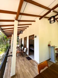 a patio with wooden ceilings and a table and chairs at Shiimmer - Ella in Ella +38 photos