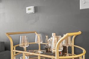a group of wine glasses sitting on a table at Upscale King 2BR Suite Mins Uptown Charlotte in Charlotte +20 photos