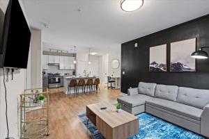 a living room with a couch and a table at Upscale King 3BR Suite to Uptown Charlotte in Charlotte