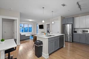 a large kitchen with a sink and a counter at Upscale King 3BR Suite to Uptown Charlotte in Charlotte +15 photos