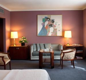 a hotel room with a couch and a table at Starhotels Du Parc in Parma +43 photos