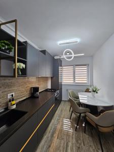 a kitchen and dining room with a table and chairs at Apartament Rosenau in Râşnov