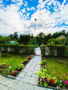 a garden with flowers and a street light at Private Villa Suite with Independent Entrance in Täby +9 photos