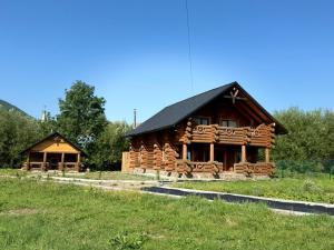 a log cabin with a black roof at Сонячна долина in Negrovets