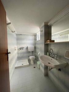 a bathroom with a toilet and a sink at COSY Urban Living in Kos Town