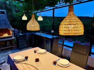 a kitchen with a table with plates on top of it at Villa Theresa Kroatien in Donji Zagon