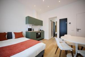 a bedroom with a bed and a table with chairs at Apartment Combaz 4 in Mellet
