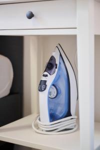 a blue and white appliance sitting on a table at Apartment Combaz 4 in Mellet