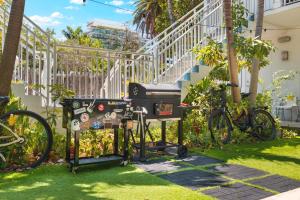 a grill in the grass next to a building at Central Miami Beach Condo w BBQ Facilities in Miami Beach