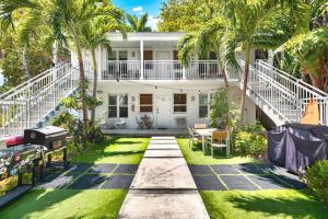 an exterior view of a house with palm trees at Central Miami Beach Condo w BBQ Facilities in Miami Beach