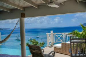 a balcony with a view of the ocean at Endless Summer Villa in Tortola Island