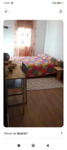 a bedroom with a bed and a table and a desk at Casa do Ruben Lisboa in Lisbon +11 photos