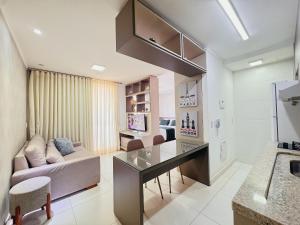 a living room with a couch and a table at Walk Bueno, Próximo Parque Vaca Brava e Goiânia Shopping. in Goiânia