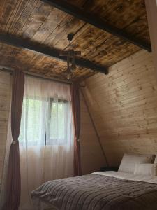 a bedroom with a bed and a window at Borlova Frame in Borlova