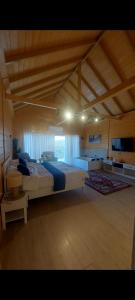 a large bedroom with two beds in a room at اكواخ ارض الخير in Ajloun