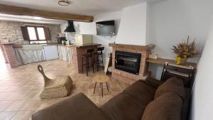 a living room with a couch and a fireplace at La casa de la tía Guille in Medranda