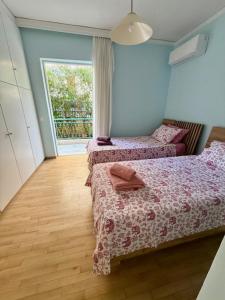 a bedroom with two beds and a window at Avra Deluxe Apartment in Athens