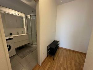 a bathroom with a sink and a washing machine at Rooftop 1 bed sleeps 4 in Luxembourg +15 photos