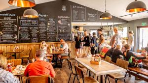 a group of people sitting at tables in a restaurant at Whitemills Wake and Aqua Park Lodge One in Richborough +17 photos