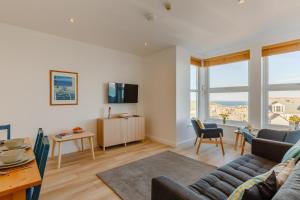 a living room with a couch and a table at 1 Seabirds House in St Ives