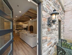 a brick wall with a door leading into a living room at Carters Court Grand Escape in Franklin