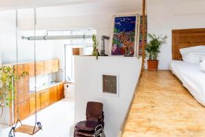 a room with a bed and a chair in it at Einzigartiges 140qm LOFT – Party ist erlaubt! in Berlin
