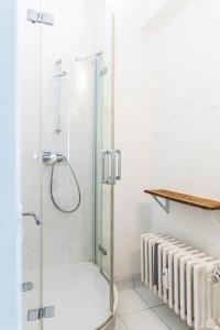 a shower with a glass door in a bathroom at Einzigartiges 140qm LOFT – Party ist erlaubt! in Berlin