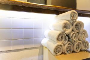 a stack of towels sitting on a shelf in a bathroom at Einzigartiges 140qm LOFT – Party ist erlaubt! in Berlin +42 photos