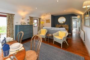 a living room with a couch and a table at Trefaes Bach in Abersoch