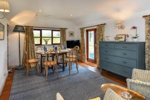 a dining room with a table and chairs at Trefaes Bach in Abersoch +14 photos