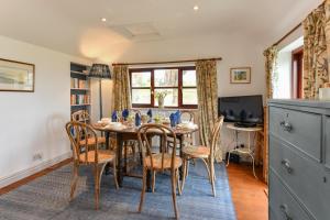 a dining room with a table and chairs at Trefaes Bach in Abersoch