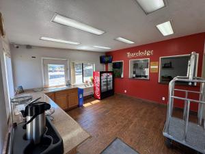 a large room with a kitchen with a counter and aperature at Travelodge by Wyndham Klamath Falls in Klamath Falls