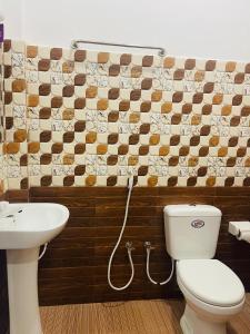 a bathroom with a toilet and a sink at Nachchi Beach Sweet Stay in Nilaveli