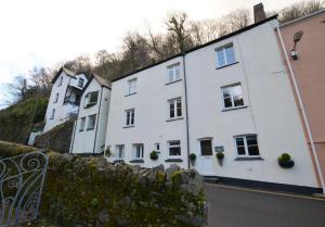 a row of white houses on the side of a street at Fox Cottage in Lynmouth