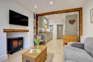 a living room with a couch and a fireplace at Fox Cottage in Lynmouth +12 photos