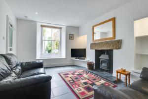 a living room with a couch and a fireplace at Carvosso in Mousehole