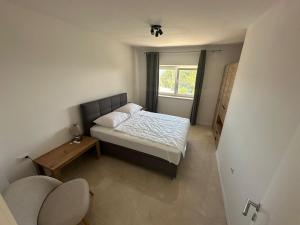 a small bedroom with a bed and a window at Eureka in Crikvenica