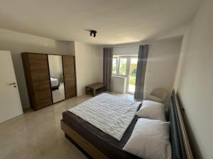a bedroom with a bed and a large mirror at Eureka in Crikvenica