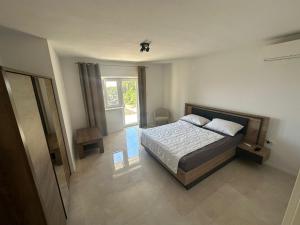 a bedroom with a bed and a window at Eureka in Crikvenica