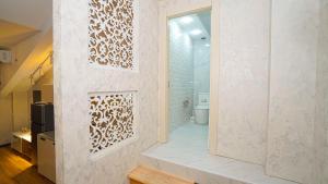 トビリシにあるwhite houseのトイレと鏡付きの壁があるバスルーム
