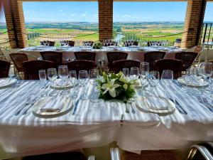 a set of tables with white tablecloths and flowers at Hospedium Hotel Juan II in Toro +54 photos