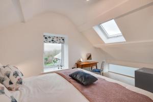a bedroom with a bed with a pillow on it at Cuddfan Idris in Dolgellau