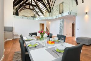 a dining room with a white table and chairs at St Aelrhiws Church in Rhiw