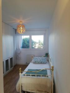a bedroom with a bed and a window and a chandelier at Mar, playas y montañas in Miengo