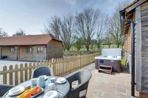 a patio with a table and chairs and a barbecue at 2 Bed in Tenterden oc-tn606 in Stone